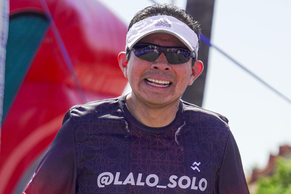 Lalo Solo running a race in a @Lalo_Solo shirt